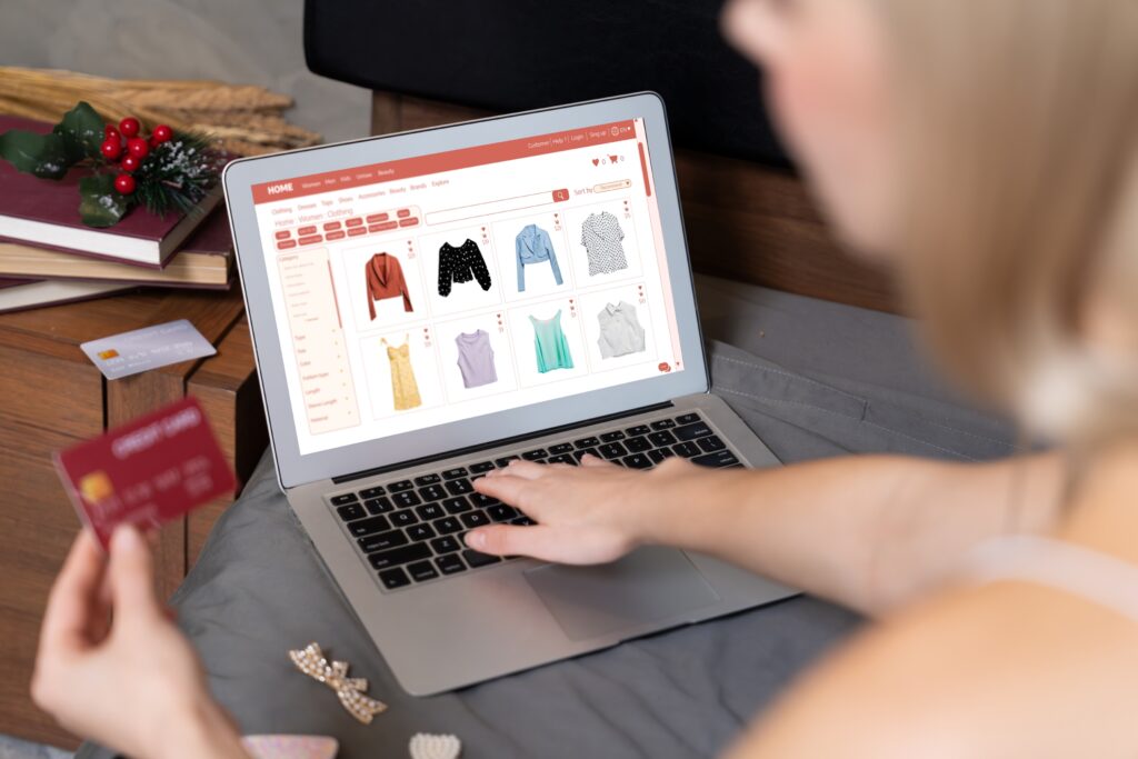 young woman using laptop with credit card internet banking blithe